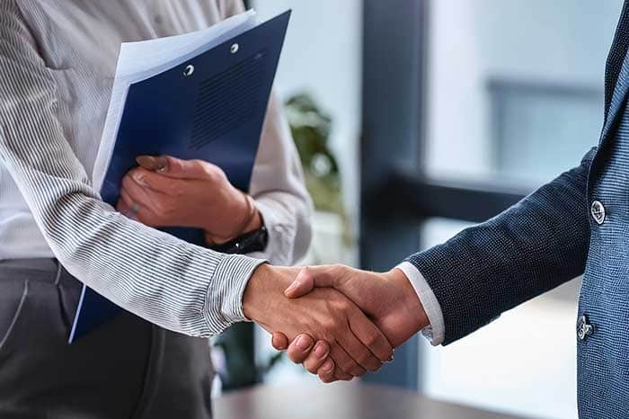 two people shaking hands after the presentation of the invoice to homeowner in Steamboat Springs, CO